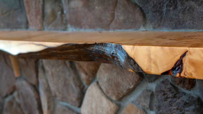 Hoobler Stone fire place with a raw edge Huon Pine mantle